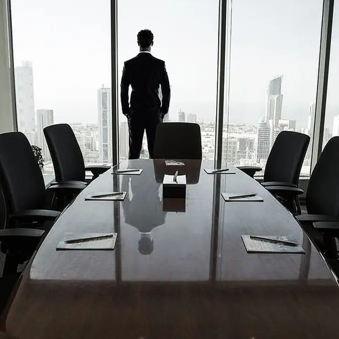 Executive looking out over the city from a boardroom